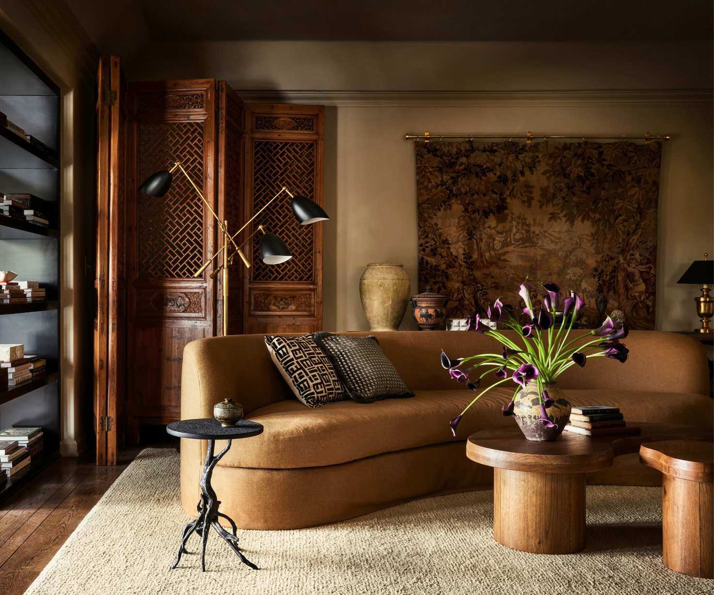 Living room design by Plaster &amp;amp; Patina painted in Riverbed by Dunn Edwards featuring a curved sofa in tan fabric