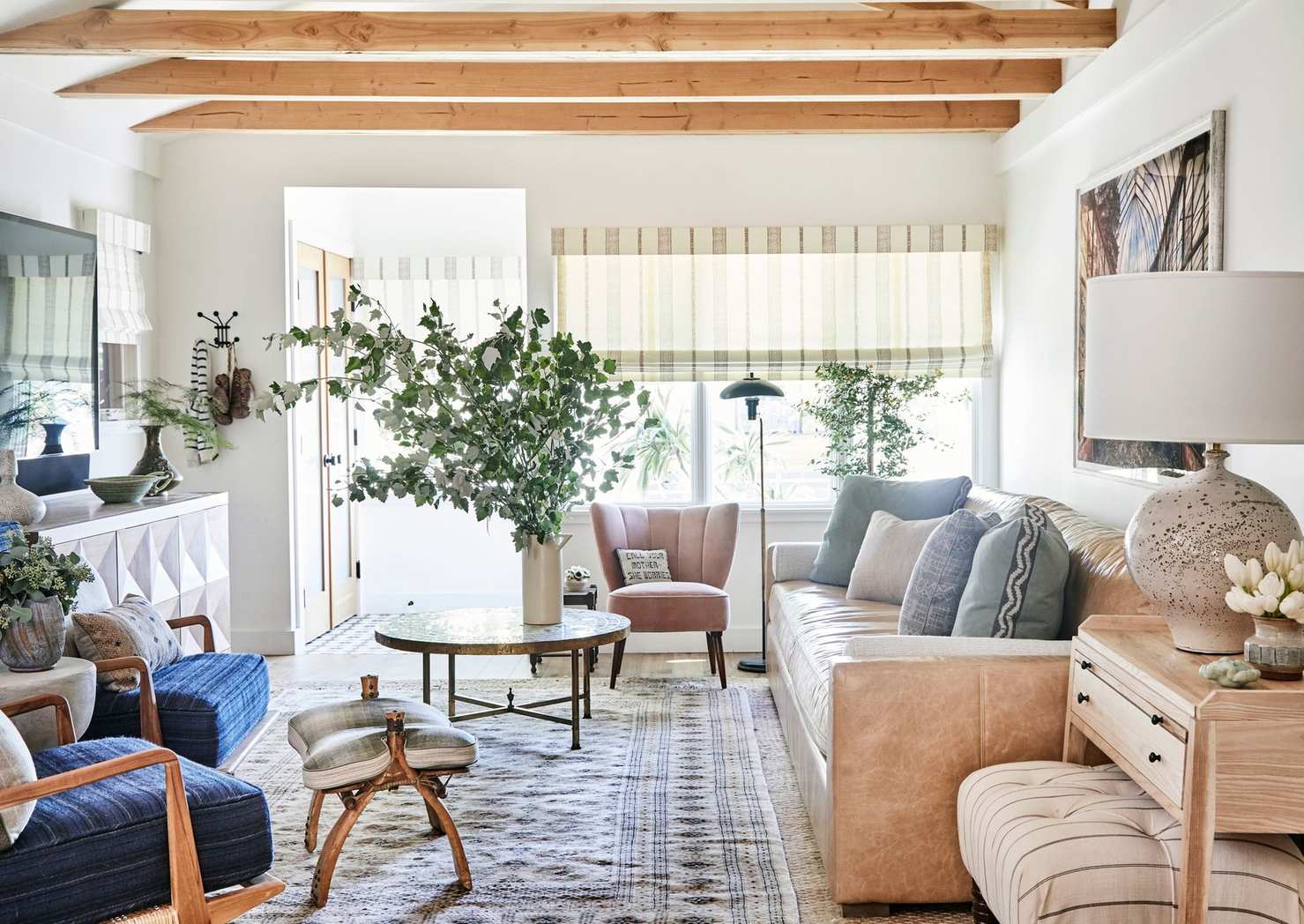 A bright living room full of comfy furniture and soft colours.