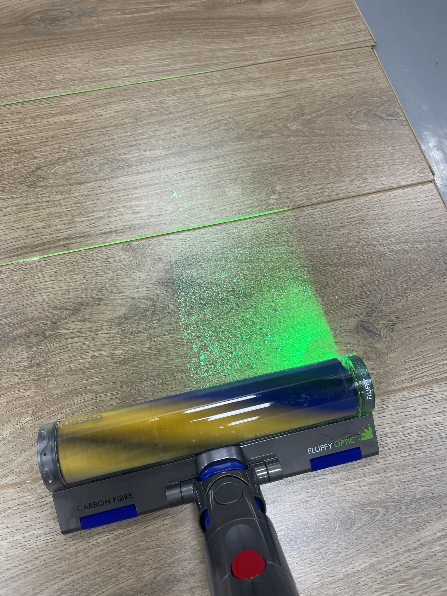 Dyson V12 Detect Slim with Fluffy Optic cleaner head, illuminating hidden dust
