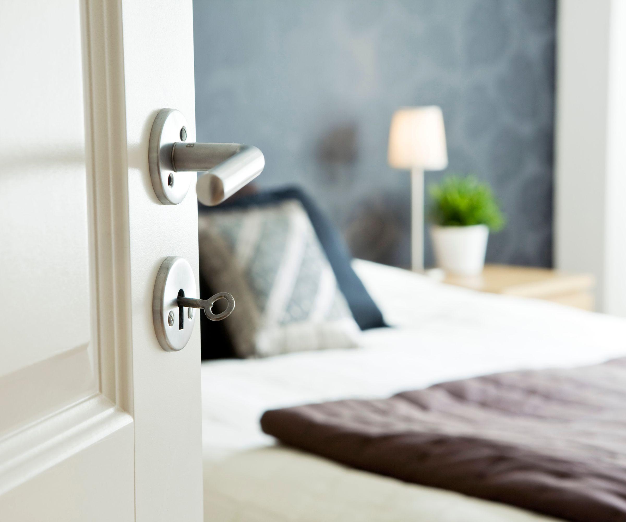 A view of a bed through an open doorway