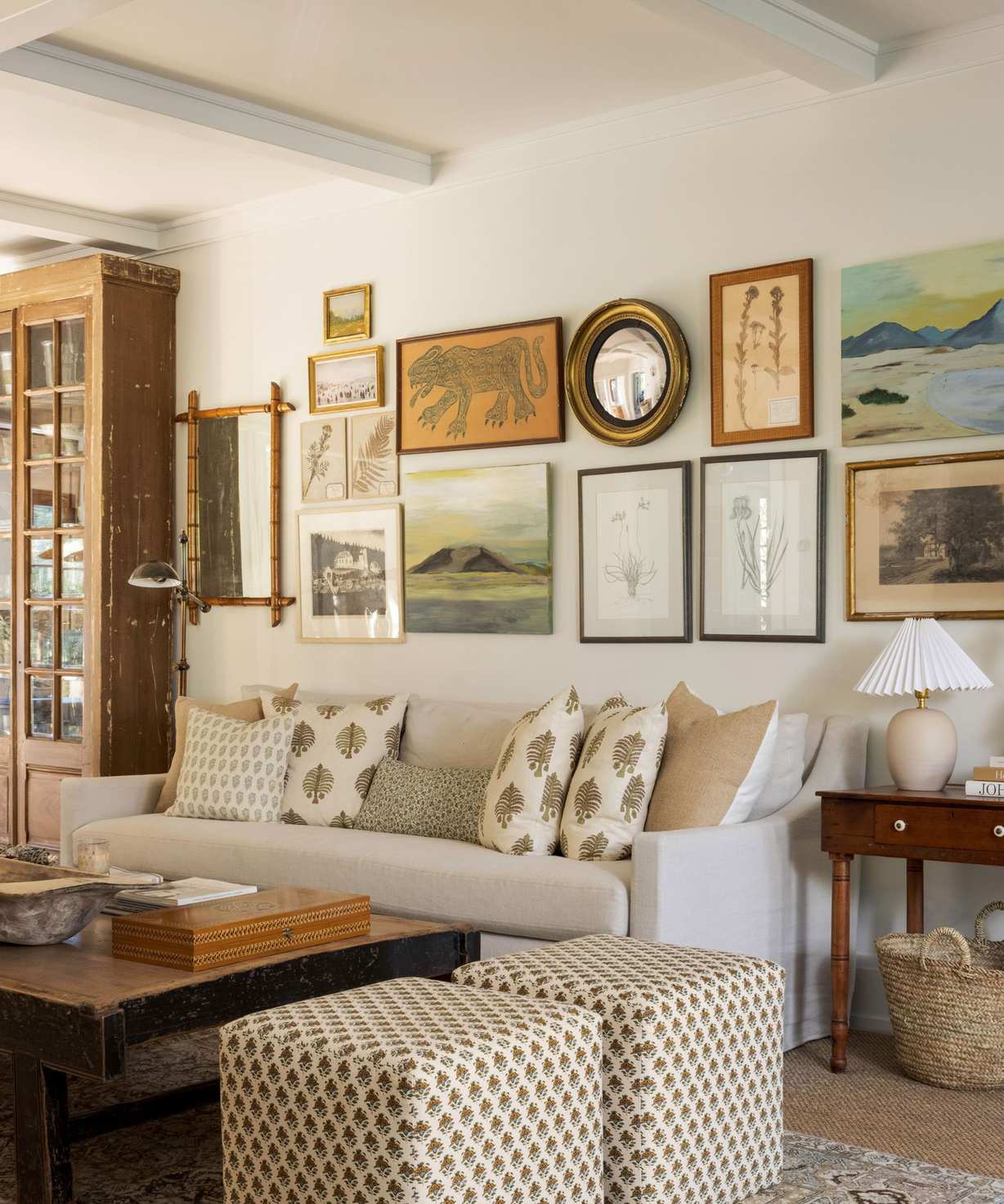 living room with white sofas gallery wall and soft neutral colors and wooden floors